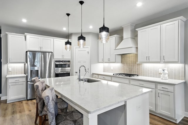 4364 Ginger Dr, Minnetrista, MN 55331 - kitchen with stainless steel appliances, custom range hood, backsplash, recessed lighting, and white cabinets
