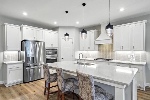 4364 Ginger Dr, Minnetrista, MN 55331 - kitchen with appliances with stainless steel finishes, custom exhaust hood, light wood-style flooring, backsplash, and recessed lighting