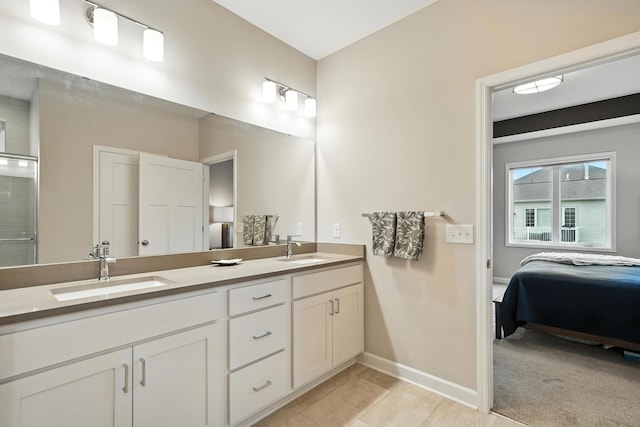 4364 Ginger Dr, Minnetrista, MN 55331 - ensuite bathroom featuring double vanity, tile patterned floors, and a shower with door