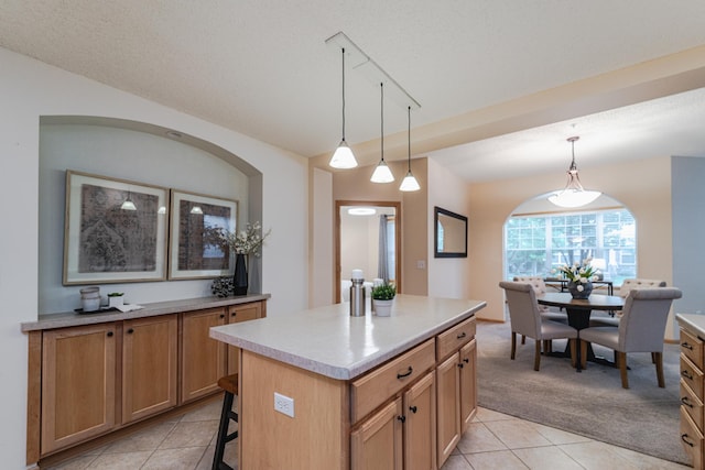 625 Wesley Commons Dr Unit 36, Golden Valley, MN 55427 - kitchen with light tile patterned floors, light colored carpet, pendant lighting, light countertops, and a center island