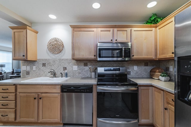 625 Wesley Commons Dr Unit 36, Golden Valley, MN 55427 - kitchen featuring stainless steel appliances, light countertops, light brown cabinets, tasteful backsplash, and recessed lighting