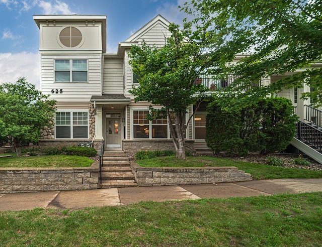 625 Wesley Commons Dr Unit 36, Golden Valley, MN 55427 - view of front facade featuring stone siding, a front yard, and stairway