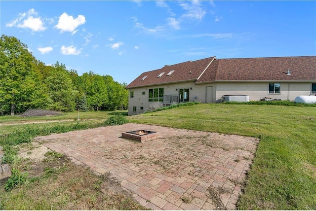 2832 130th Ave, Glenwood City, WI 54013 - rear view of property featuring an outdoor fire pit, a patio area, and a lawn