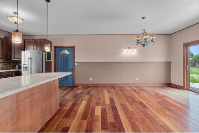 2832 130th Ave, Glenwood City, WI 54013 - kitchen with high end fridge, light countertops, wood finished floors, decorative backsplash, and a chandelier