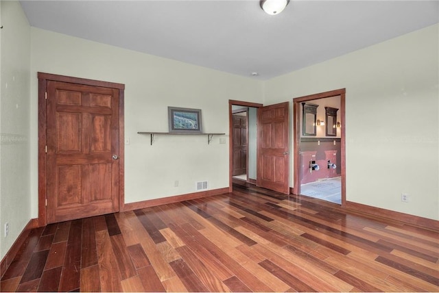 2832 130th Ave, Glenwood City, WI 54013 - unfurnished bedroom featuring wood finished floors and baseboards