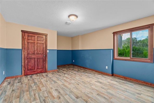2832 130th Ave, Glenwood City, WI 54013 - empty room with wood finished floors and a textured ceiling
