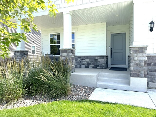 15613 116th Ave N, Dayton, MN 55369 - entrance to property featuring a porch and stone siding