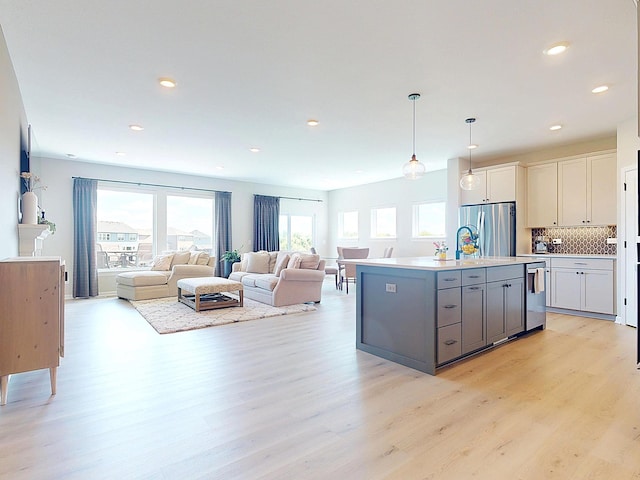 15613 116th Ave N, Dayton, MN 55369 - kitchen with stainless steel appliances, light wood-type flooring, backsplash, light countertops, and recessed lighting