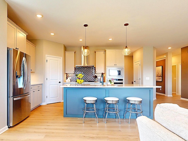 15613 116th Ave N, Dayton, MN 55369 - kitchen with stainless steel appliances, wall chimney range hood, light wood-style flooring, recessed lighting, and light countertops