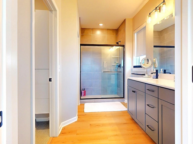 15613 116th Ave N, Dayton, MN 55369 - bathroom featuring a shower stall, wood finished floors, double vanity, and recessed lighting