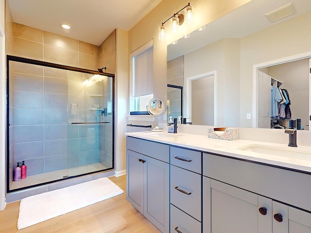 15613 116th Ave N, Dayton, MN 55369 - bathroom with double vanity, a stall shower, wood finished floors, and recessed lighting