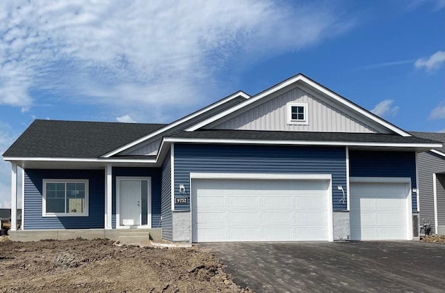 9752 32nd St NE, Saint Michael, MN 55376 - ranch-style house featuring an attached garage, driveway, board and batten siding, and roof with shingles