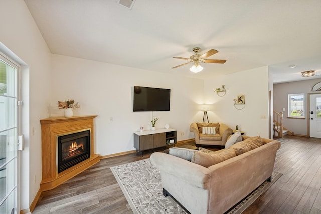 2840 Brewers Ln, Stillwater, MN 55082 - living area with wood finished floors, ceiling fan, a glass covered fireplace, and stairs