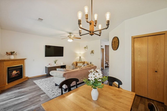 2840 Brewers Ln, Stillwater, MN 55082 - dining area featuring a ceiling fan, wood finished floors, a chandelier, and a glass covered fireplace