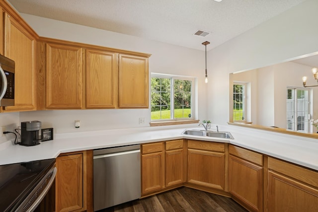 2840 Brewers Ln, Stillwater, MN 55082 - kitchen with stainless steel appliances, light countertops, dark wood-style floors, and hanging light fixtures