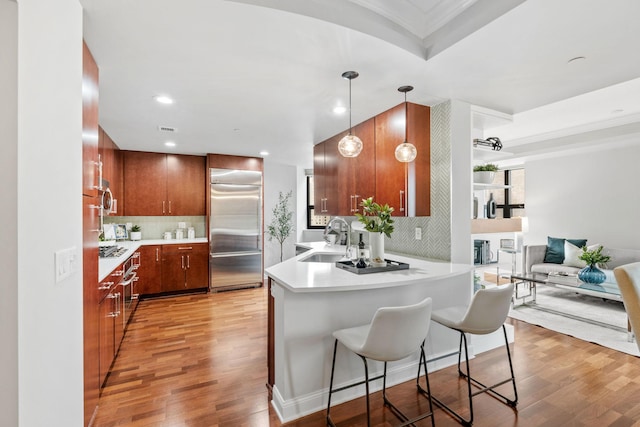 100 3rd Ave S Unit 805, Minneapolis, MN 55401 - kitchen with a peninsula, light wood finished floors, appliances with stainless steel finishes, light countertops, and open floor plan