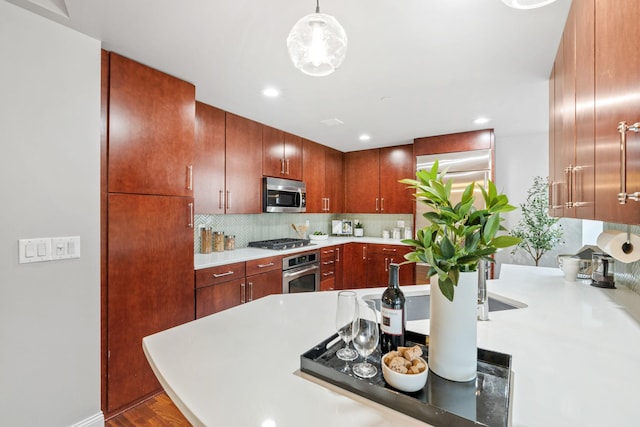 100 3rd Ave S Unit 805, Minneapolis, MN 55401 - kitchen featuring stainless steel appliances, light countertops, tasteful backsplash, recessed lighting, and wood finished floors