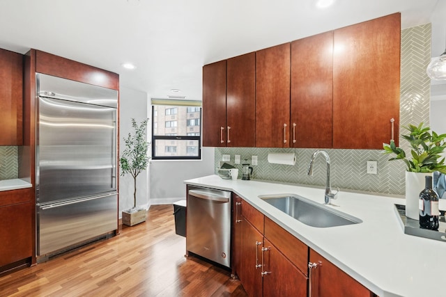 100 3rd Ave S Unit 805, Minneapolis, MN 55401 - kitchen with appliances with stainless steel finishes, light countertops, wood finished floors, backsplash, and recessed lighting