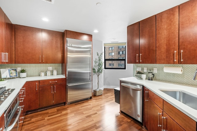 100 3rd Ave S Unit 805, Minneapolis, MN 55401 - kitchen with appliances with stainless steel finishes, backsplash, light wood-style flooring, light countertops, and recessed lighting