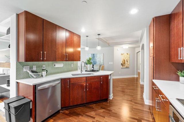 100 3rd Ave S Unit 805, Minneapolis, MN 55401 - kitchen featuring dishwasher, dark wood-style flooring, backsplash, light countertops, and a peninsula