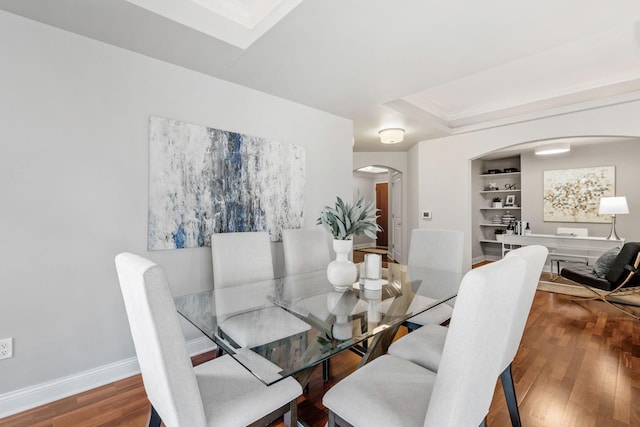 100 3rd Ave S Unit 805, Minneapolis, MN 55401 - dining room featuring arched walkways, wood finished floors, built in shelves, a raised ceiling, and crown molding