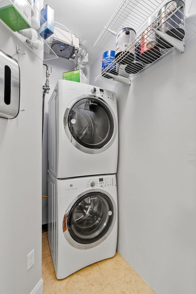 100 3rd Ave S Unit 805, Minneapolis, MN 55401 - washroom featuring estacked washer and dryer and tile patterned floors