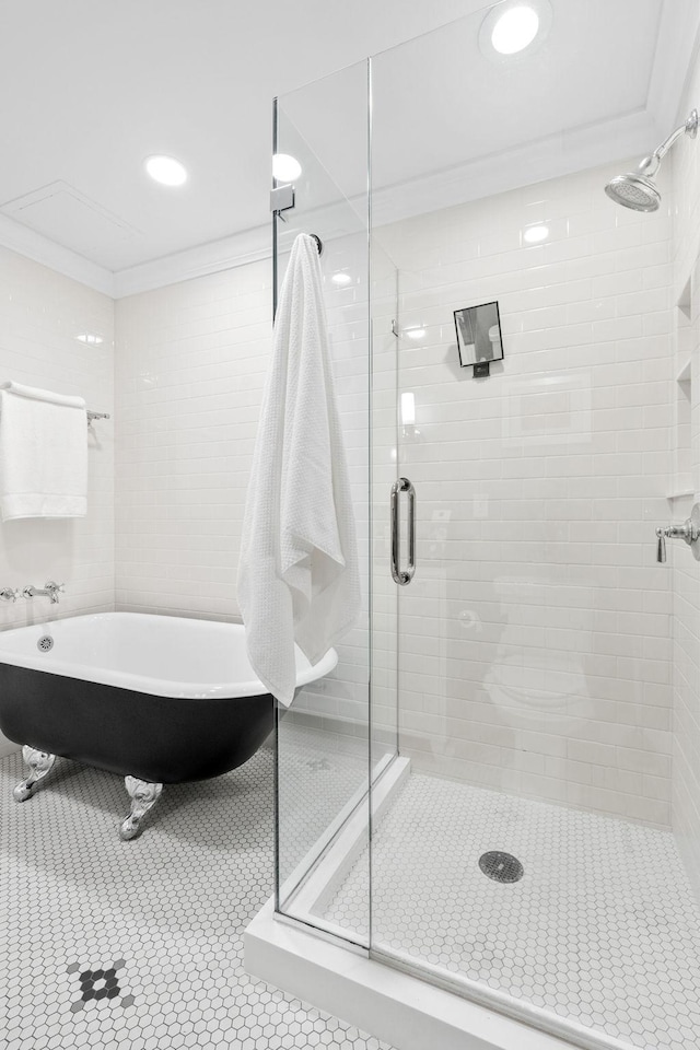100 3rd Ave S Unit 805, Minneapolis, MN 55401 - bathroom with crown molding, a shower stall, a freestanding bath, and tile patterned flooring