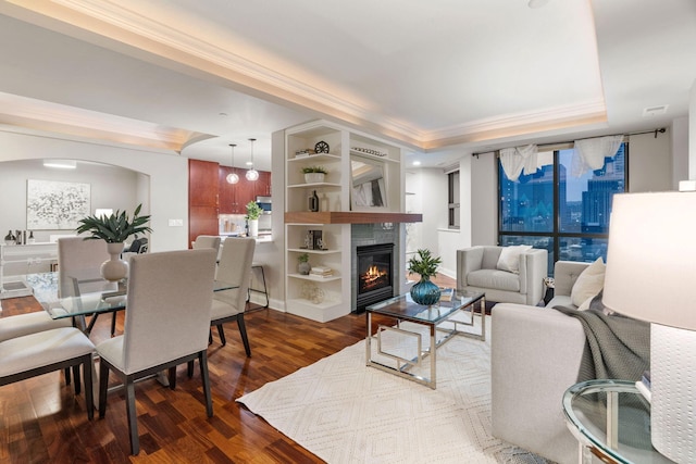 100 3rd Ave S Unit 805, Minneapolis, MN 55401 - living area featuring wood finished floors, a tray ceiling, arched walkways, ornamental molding, and a glass covered fireplace