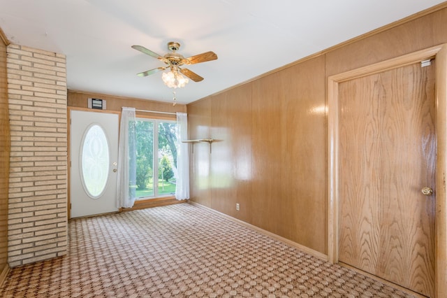 2808 34th Ave NE, Saint Anthony, MN 55418 - entryway featuring ceiling fan, wooden walls, and carpet flooring