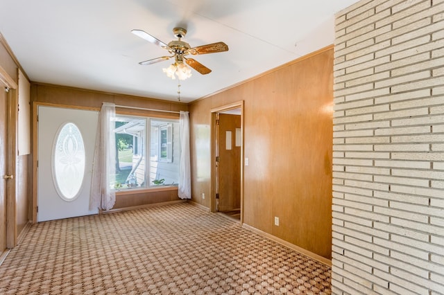 2808 34th Ave NE, Saint Anthony, MN 55418 - carpeted foyer entrance featuring ceiling fan, wood walls, and crown molding