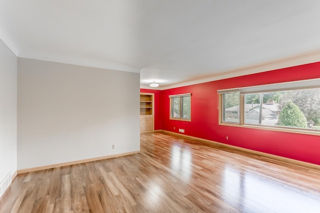 2808 34th Ave NE, Saint Anthony, MN 55418 - spare room featuring wood finished floors and built in shelves