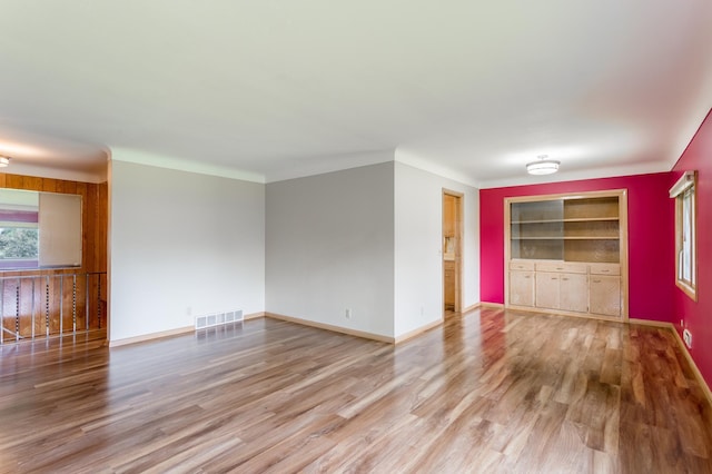2808 34th Ave NE, Saint Anthony, MN 55418 - spare room with wood finished floors and built in shelves