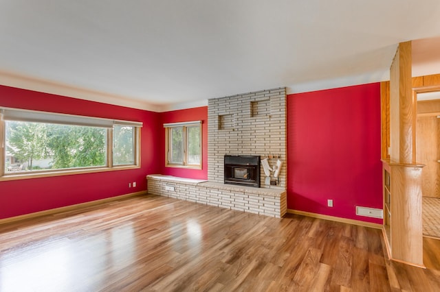 2808 34th Ave NE, Saint Anthony, MN 55418 - unfurnished living room with wood finished floors and a fireplace