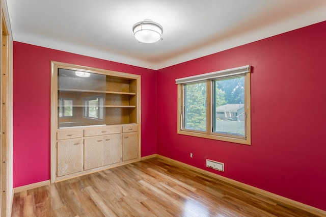 2808 34th Ave NE, Saint Anthony, MN 55418 - spare room with light wood-type flooring and baseboards