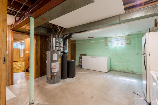 2808 34th Ave NE, Saint Anthony, MN 55418 - below grade area with white refrigerator, freestanding refrigerator, water heater, and a water softener