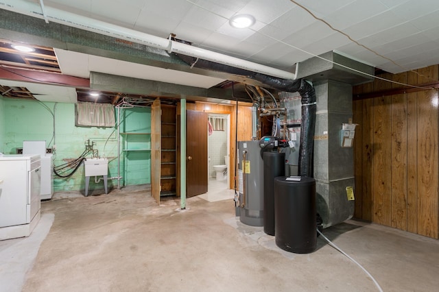 2808 34th Ave NE, Saint Anthony, MN 55418 - unfinished below grade area with separate washer and dryer, a water softener, wood walls, and gas water heater