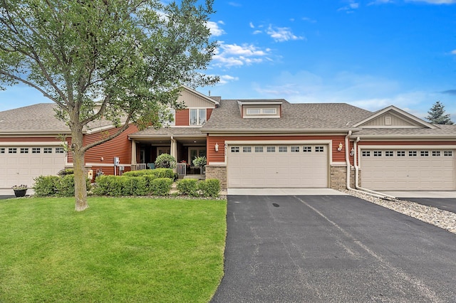 6511 98th Ln N, Brooklyn Park, MN 55445 - view of front of home featuring a front yard, asphalt driveway, a garage, roof with shingles, and brick siding