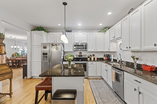 6511 98th Ln N, Brooklyn Park, MN 55445 - kitchen with stainless steel appliances, tasteful backsplash, white cabinetry, recessed lighting, and light wood-type flooring