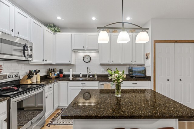 6511 98th Ln N, Brooklyn Park, MN 55445 - kitchen with appliances with stainless steel finishes, backsplash, recessed lighting, white cabinets, and dark stone counters