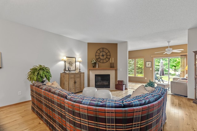 6511 98th Ln N, Brooklyn Park, MN 55445 - living area featuring a tile fireplace, light wood-type flooring, and ceiling fan