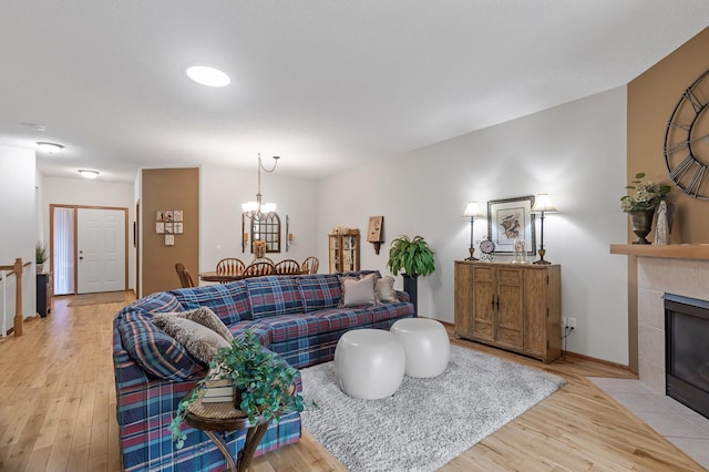 6511 98th Ln N, Brooklyn Park, MN 55445 - living area featuring light wood-style flooring, a fireplace, and a chandelier