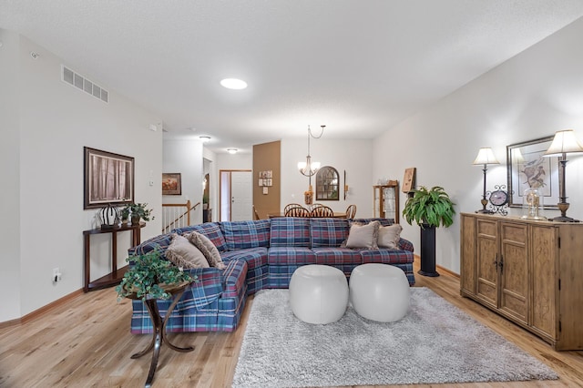6511 98th Ln N, Brooklyn Park, MN 55445 - living area featuring light wood-style flooring and a chandelier
