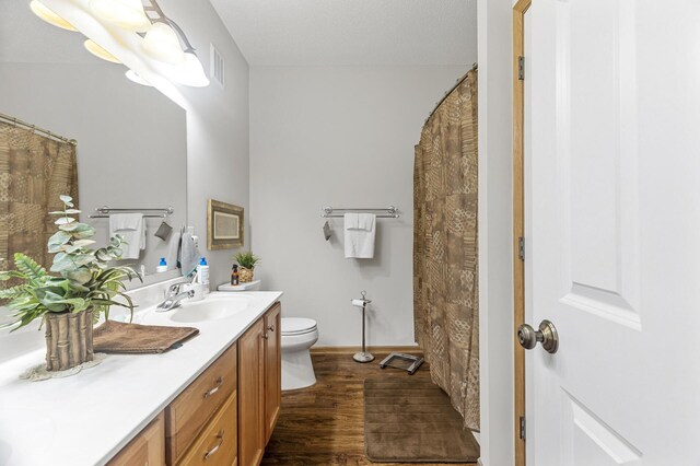 6511 98th Ln N, Brooklyn Park, MN 55445 - full bathroom with vanity, wood finished floors, and curtained shower