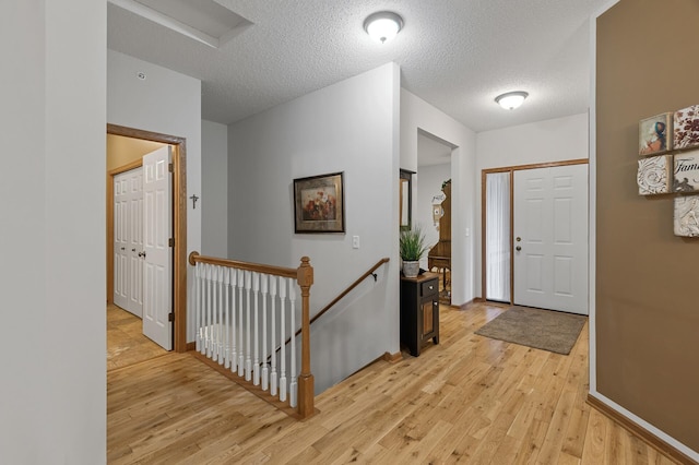 6511 98th Ln N, Brooklyn Park, MN 55445 - foyer with light wood-style flooring and a textured ceiling