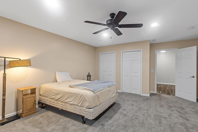 6511 98th Ln N, Brooklyn Park, MN 55445 - carpeted bedroom featuring multiple closets and a ceiling fan