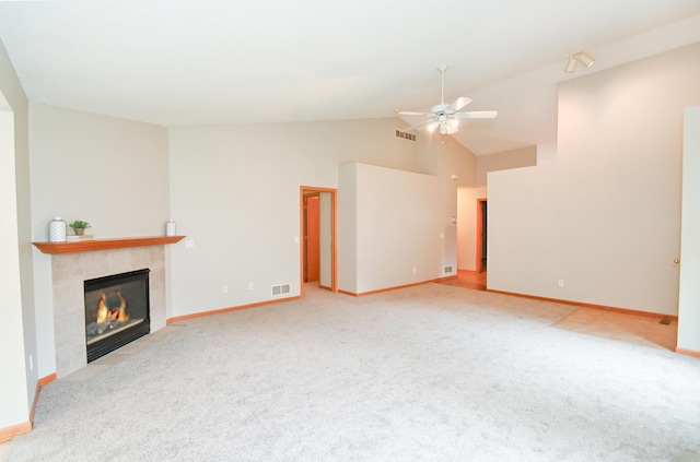 11812 37th St NE, Saint Michael, MN 55376 - unfurnished living room with a tiled fireplace, a ceiling fan, carpet flooring, and high vaulted ceiling