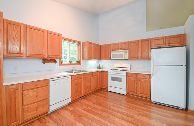 11812 37th St NE, Saint Michael, MN 55376 - kitchen with white appliances, a high ceiling, light wood-style floors, and light countertops