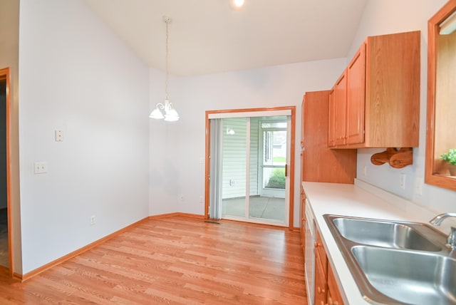 11812 37th St NE, Saint Michael, MN 55376 - kitchen with light wood-style floors, light countertops, hanging light fixtures, a chandelier, and high vaulted ceiling