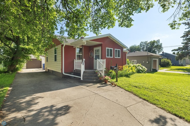 1636 2nd Ave S, Fargo, ND 58103 - bungalow-style house featuring an outdoor structure, concrete driveway, a front lawn, and a garage
