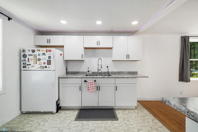 1636 2nd Ave S, Fargo, ND 58103 - kitchen with freestanding refrigerator, recessed lighting, and white cabinets